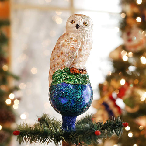 Old World Christmas closeup of hand‑painted feathers and gold accents, highlights artisan detail and texture