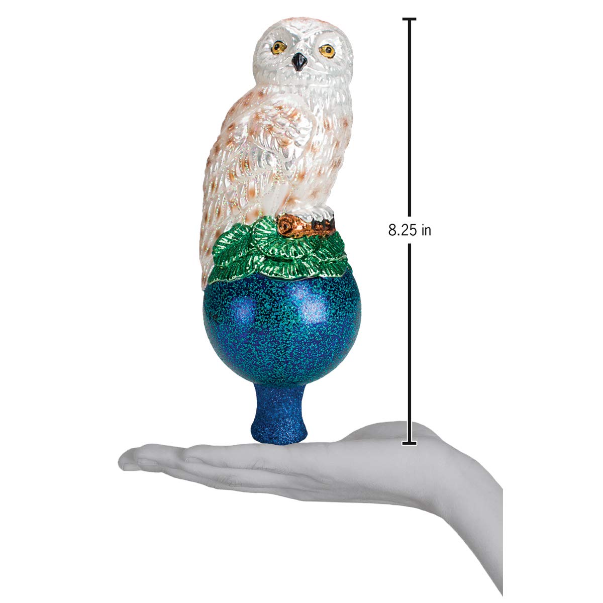 Old World Christmas snowy owl perched atop a decorated tree, provides elegant focal point for holiday décor