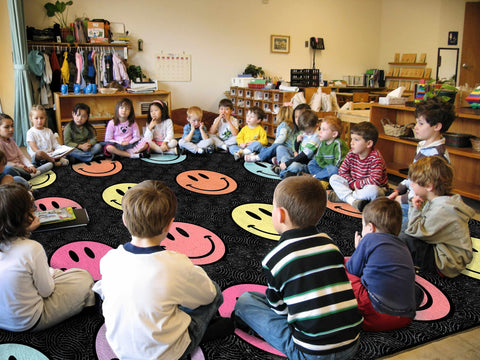 OLEEK rug beside chairs demonstrates 8x10 scale and seating capacity