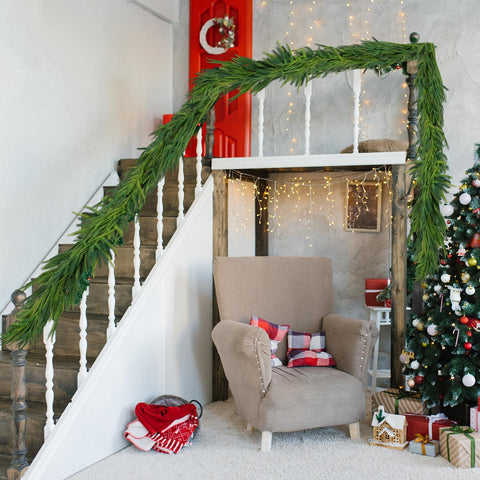 Oleitodh garland wrapped around staircase banister for a polished holiday look