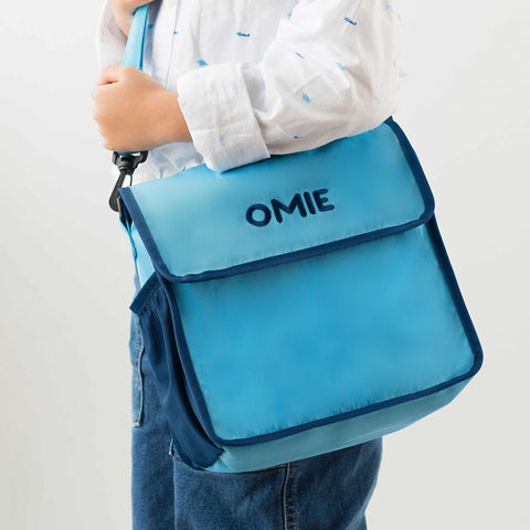 Omie interior mesh pocket holding ice pack and utensils for organization