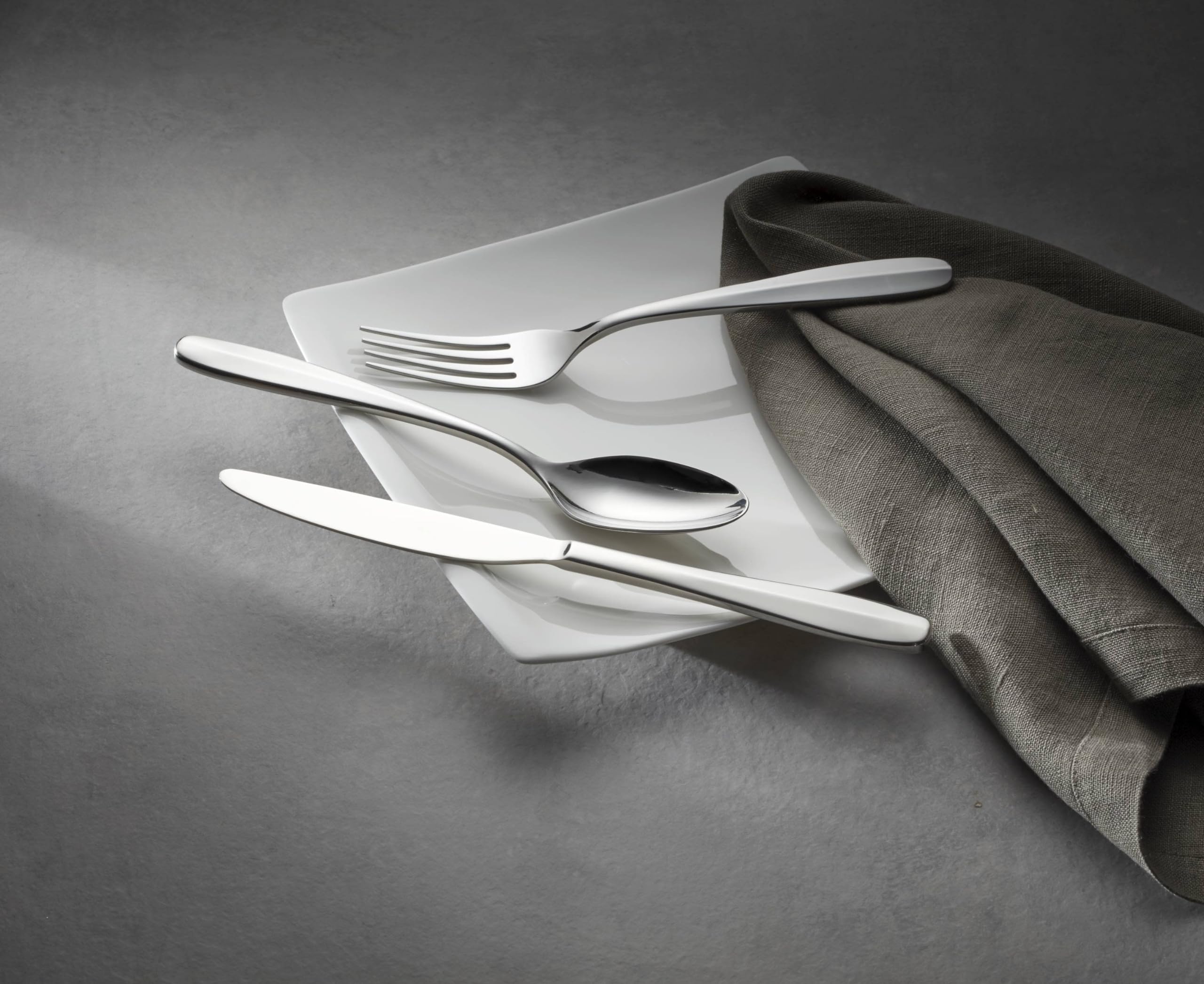Oneida Oakwood spoons stacked to show bowl shape and polished reflective finish