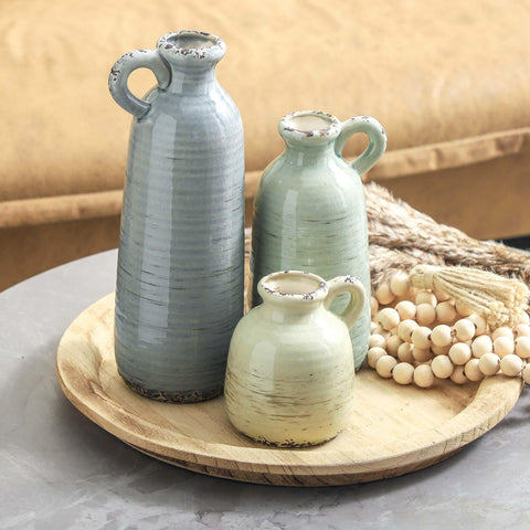 ooit grouped vases on mantel creating a layered centerpiece and visual interest