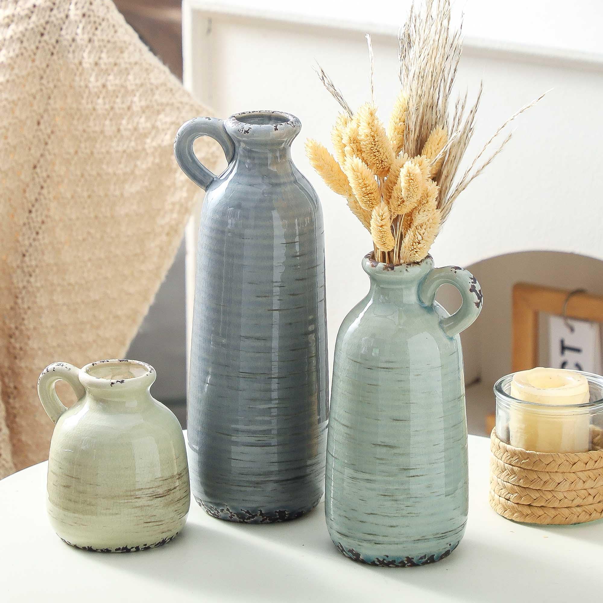 ooit vases beside books showing scale and versatility for shelf decor