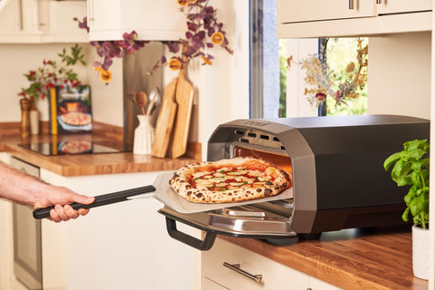 ooni peel supporting a 12-inch pizza for effortless transfer