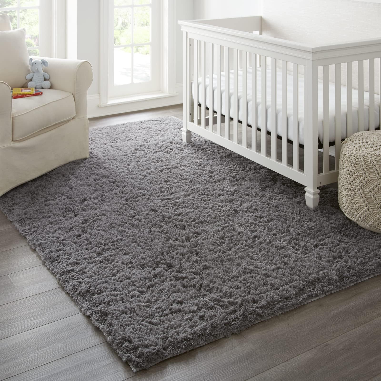Ophanie next to sofa for scale showing true 8x10 coverage helpful for shopping