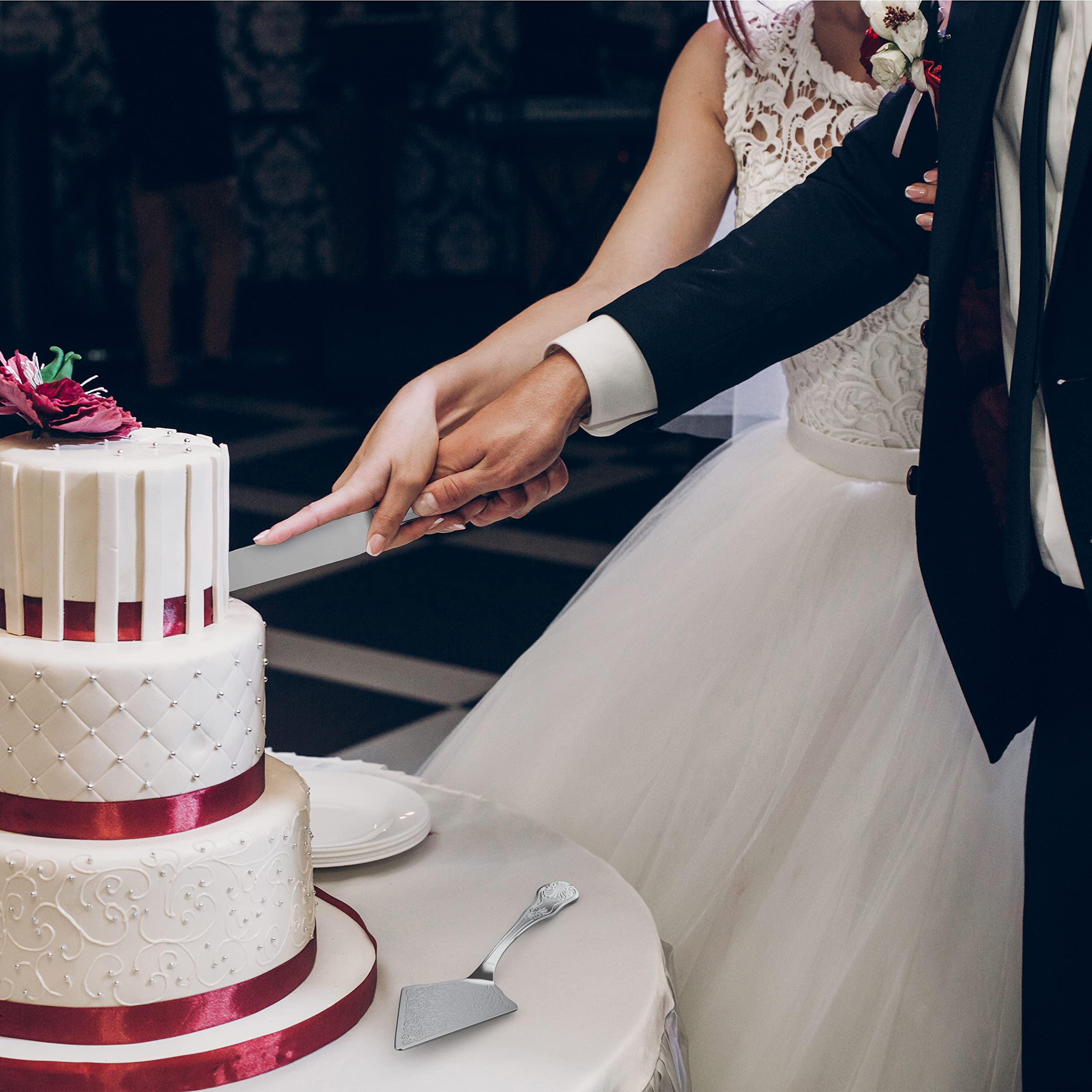 Orblue knife slicing a tiered wedding cake demonstrating clean cutting action