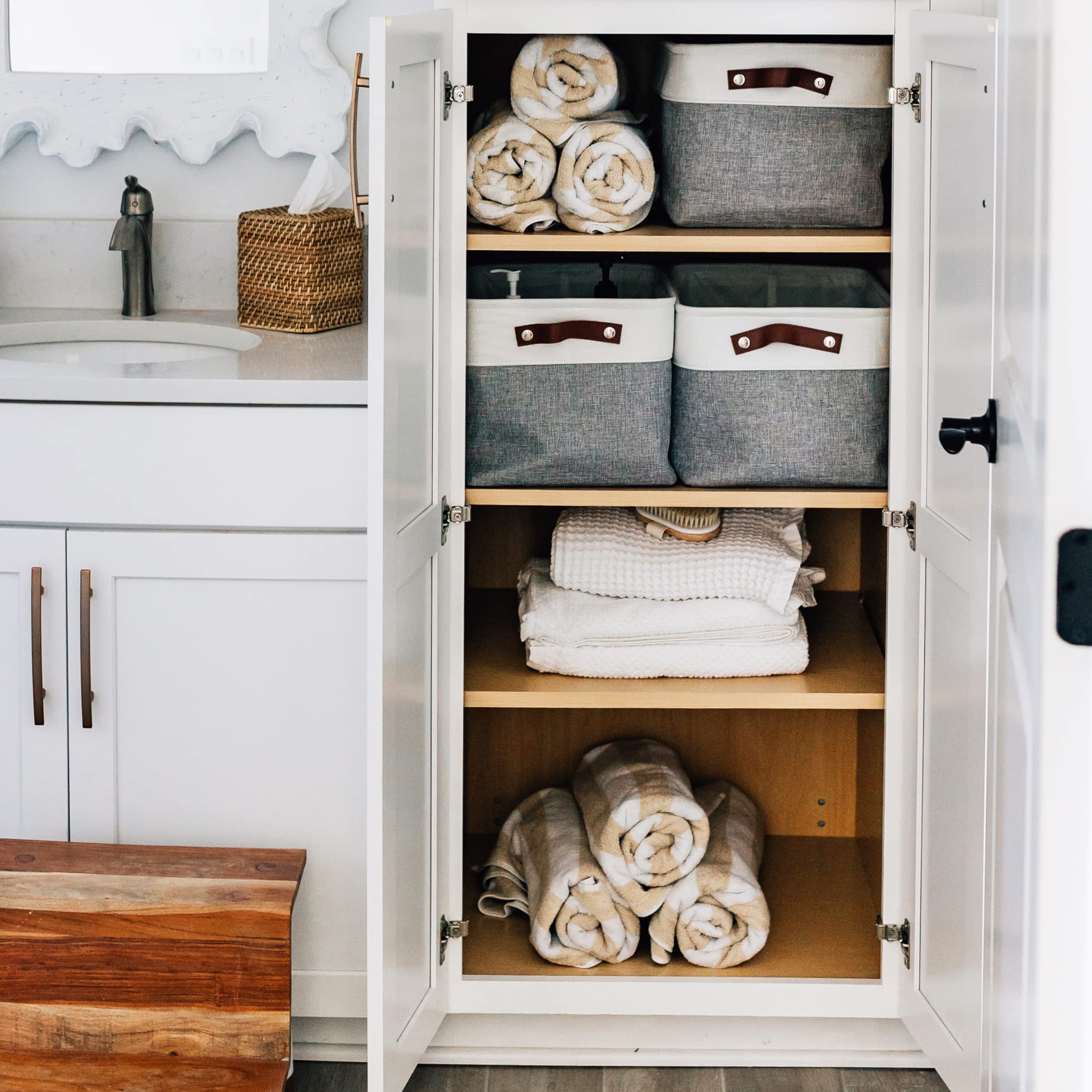 OrganiHaus holding folded linens inside to illustrate organized closet storage