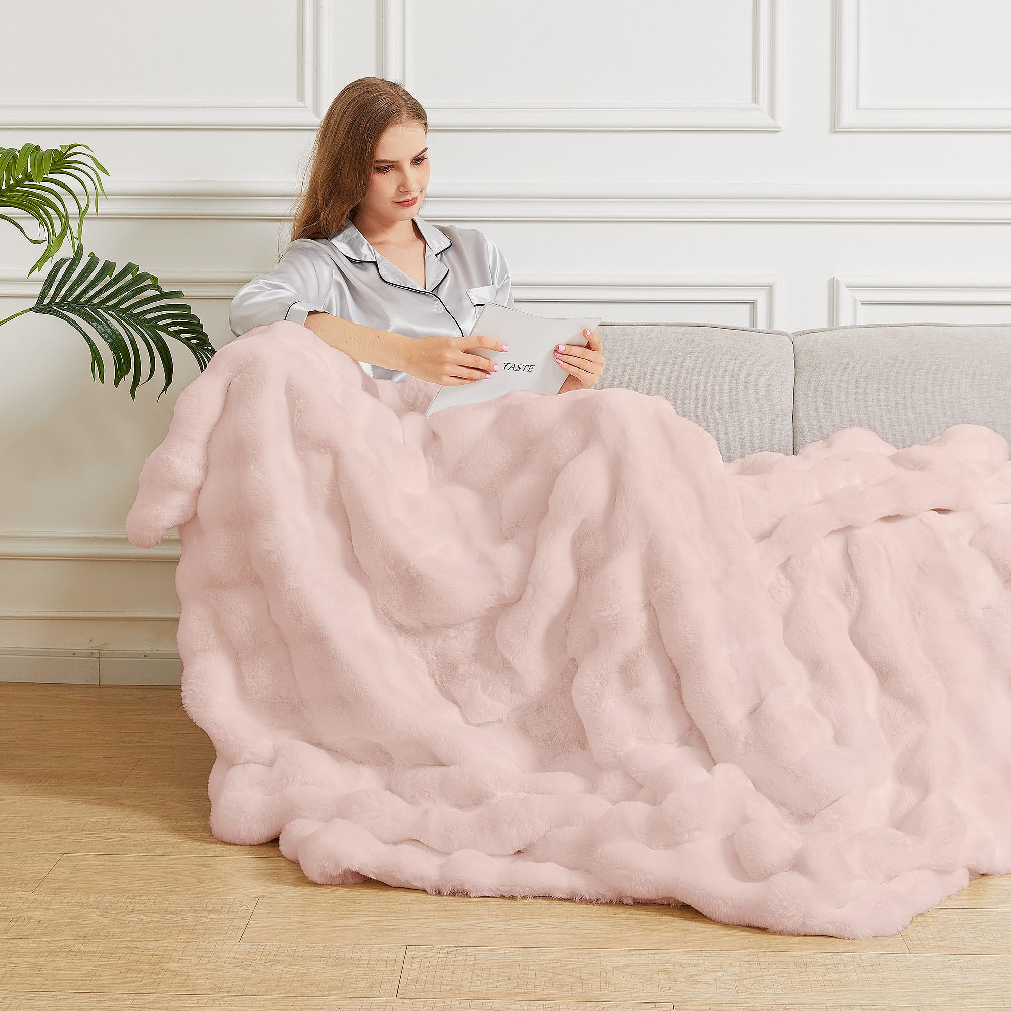 ORINOVA blanket held in hand to show 50x60 size and portable comfort