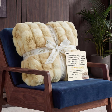 ORINOVA blanket styled on couch illustrating cozy living room warmth