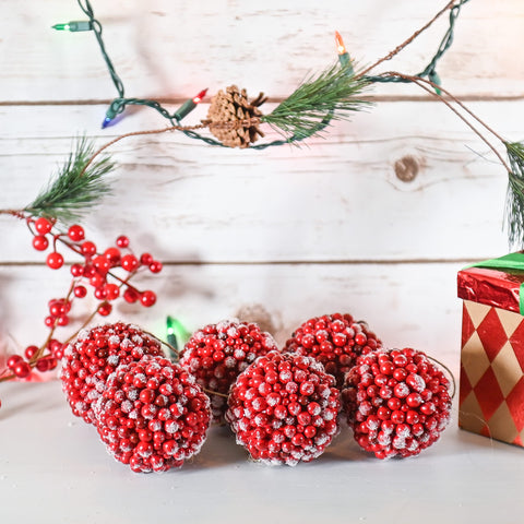 Ornativity cranberry ornaments on decorated tree adding classic color and warm glow
