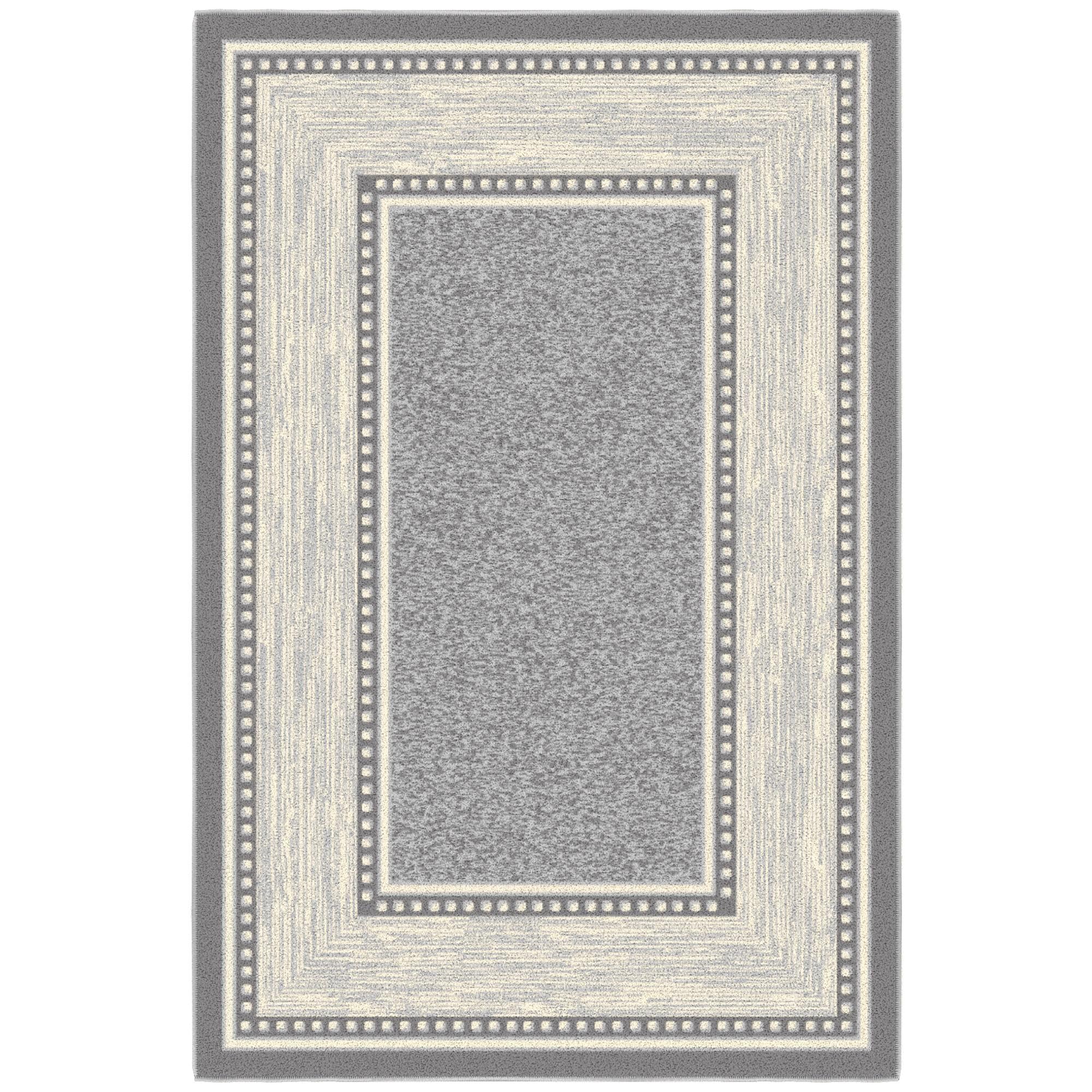 Ottomanson small rug inside an entryway capturing dirt and adding style