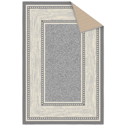 Ottomanson rug styled in living room adding warmth and compact floor coverage