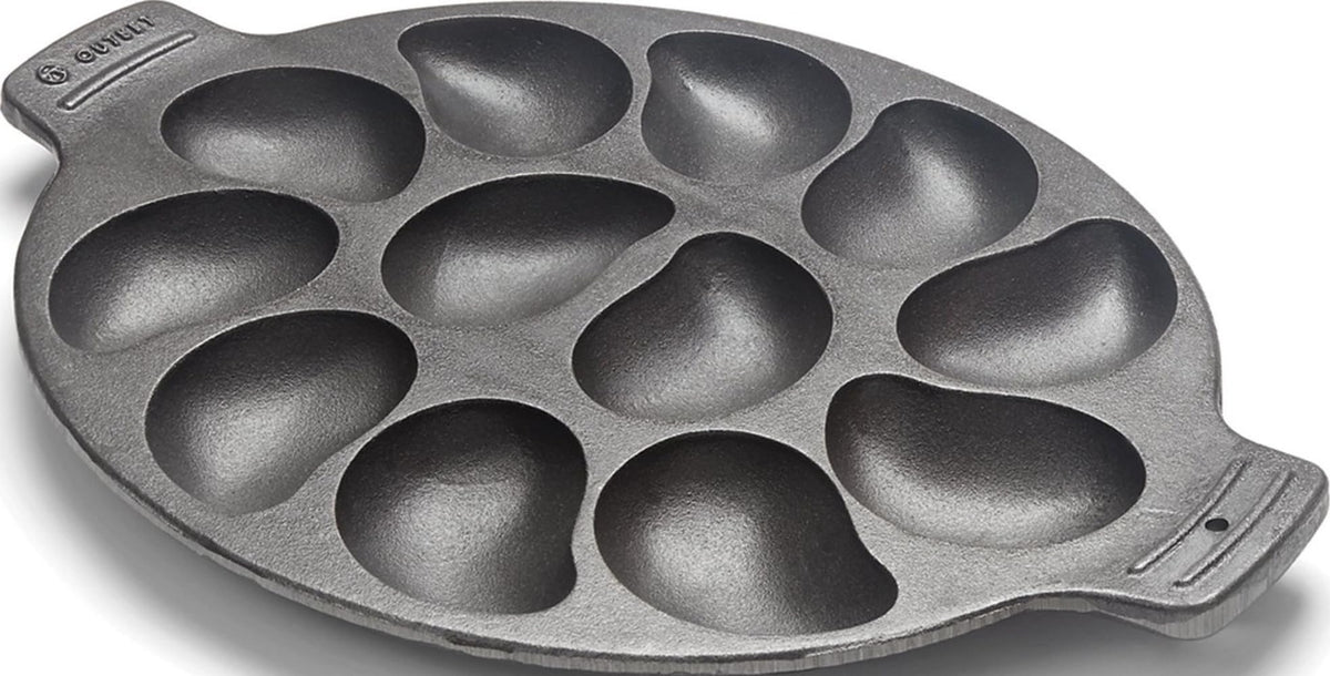 Outset cast iron oyster grill pan front view showing twelve wells and sturdy rim for serving