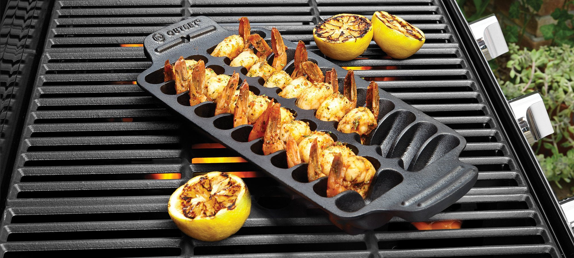 Outset shrimp pan on a hot grill cooking shrimp evenly with smoky flavor