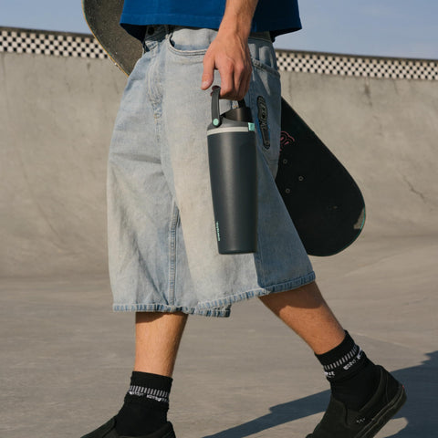 Owala FreeSip Sway on a trail with backpack showing portable outdoor hydration