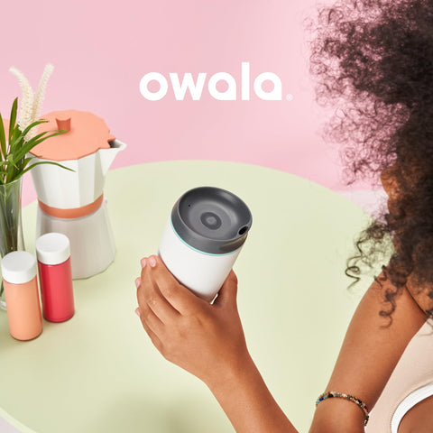 Owala SmoothSip seated in a car cup holder illustrating travel-ready convenience