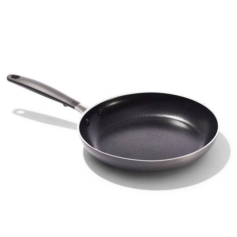 OXO 10-inch pan front view showing sleek black finish and reliable cooking surface benefit