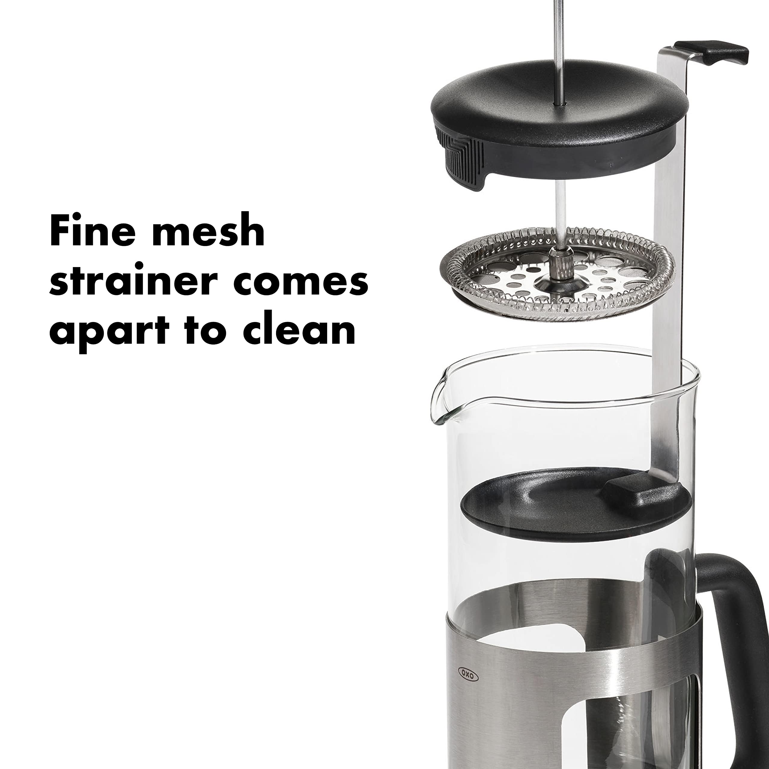 OXO Brew borosilicate carafe held to show glass clarity and flavor preservation