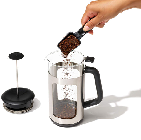 OXO Brew compact ground puck removed over trash showing tidy disposal benefit