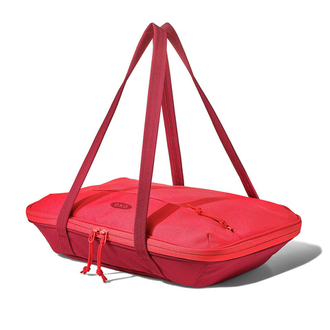 OXO Good Grips carrier front view showing zippered pocket and jam color, portable convenience