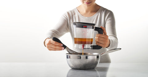 OXO Good Grips pouring juices into pan demonstrating smooth transfer and control