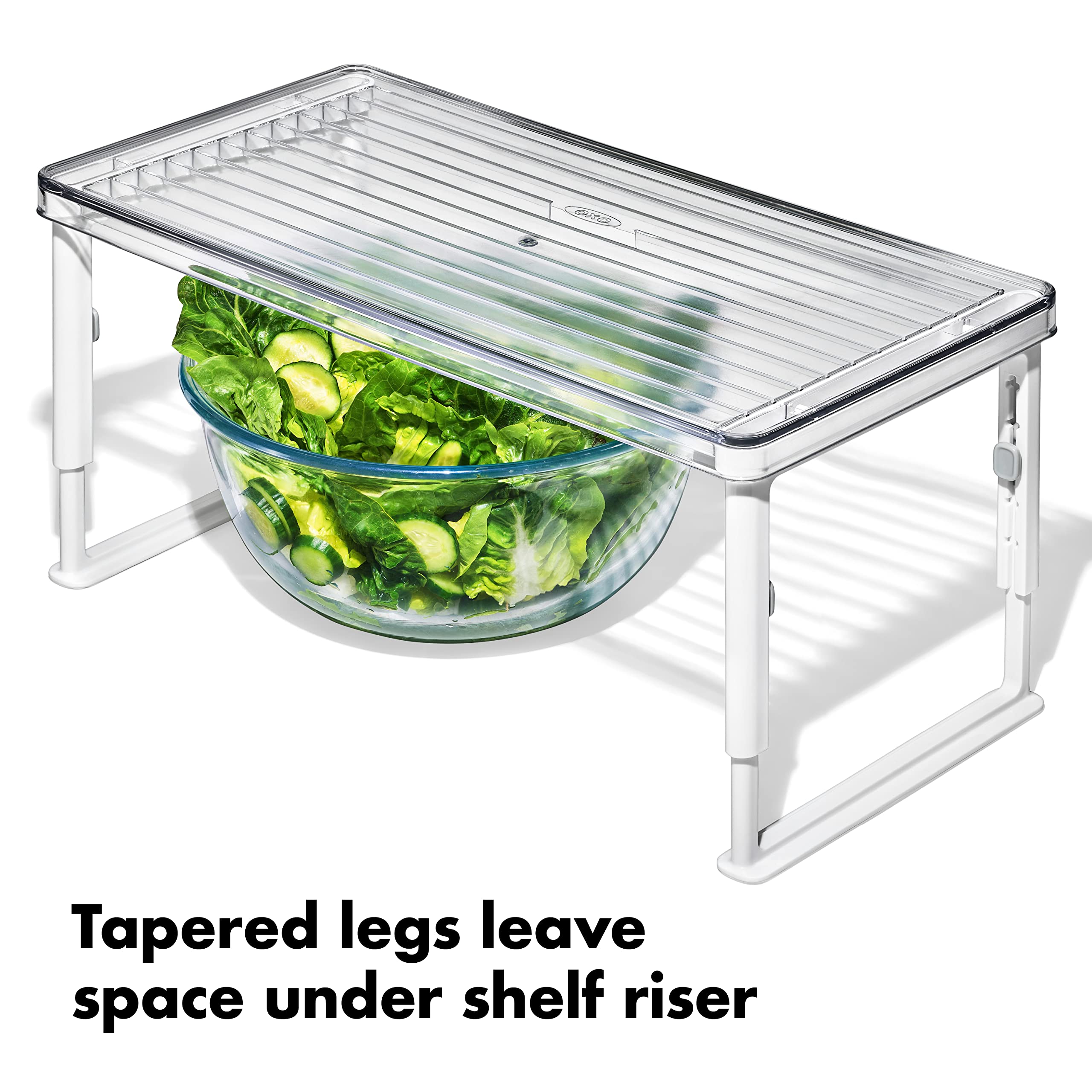 OXO Good Grips riser holding condiments to improve fridge organization and visibility