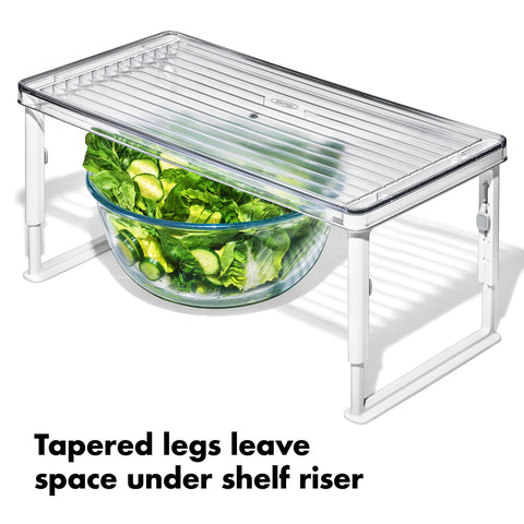 OXO Good Grips riser holding condiments to improve fridge organization and visibility