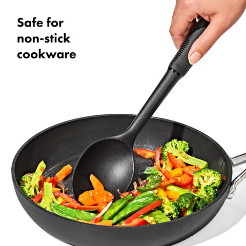 OXO utensils stirring sauce in pan demonstrating safe use on non-stick cookware benefit