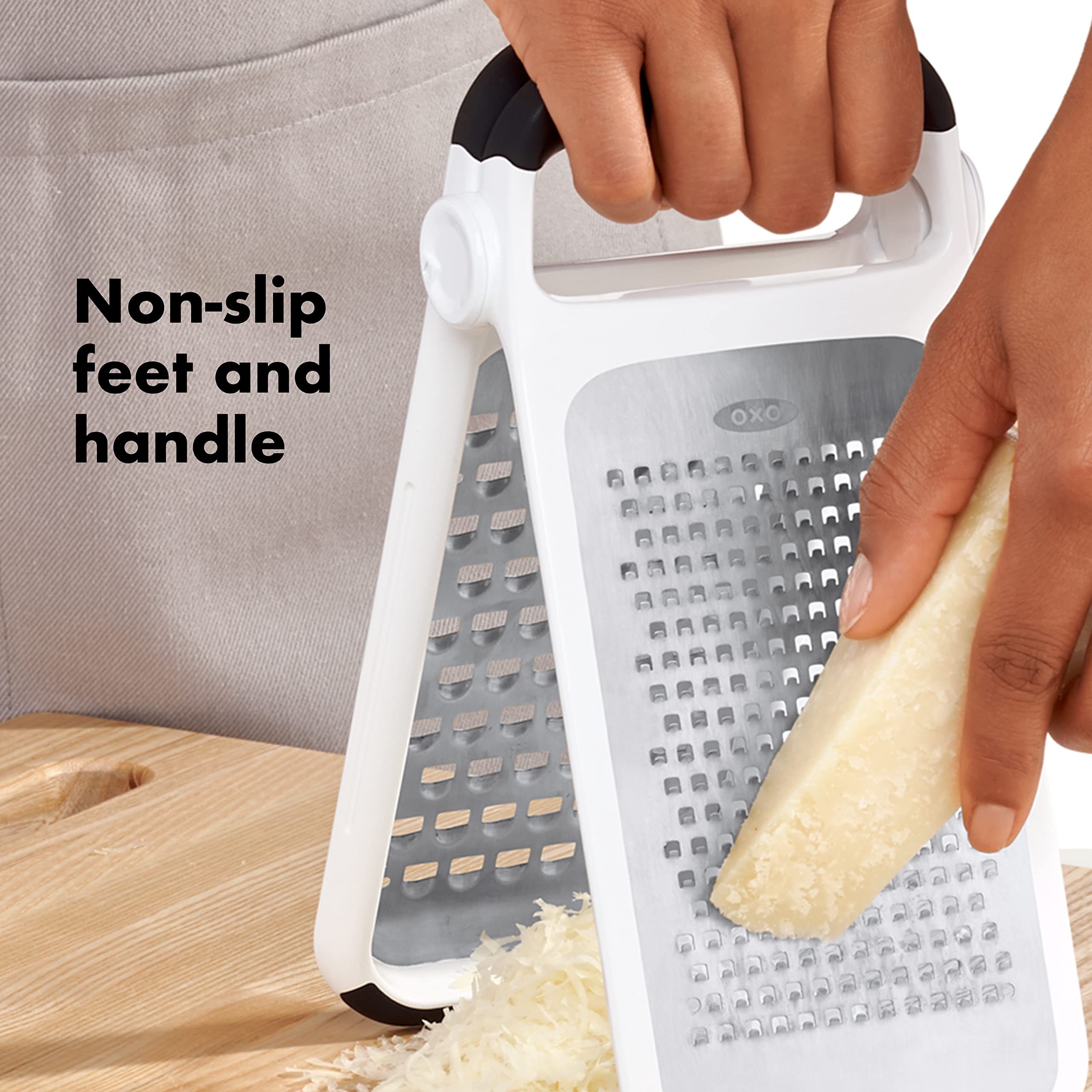 OXO grater clipped to cutting board in use for stable, large-area grating control