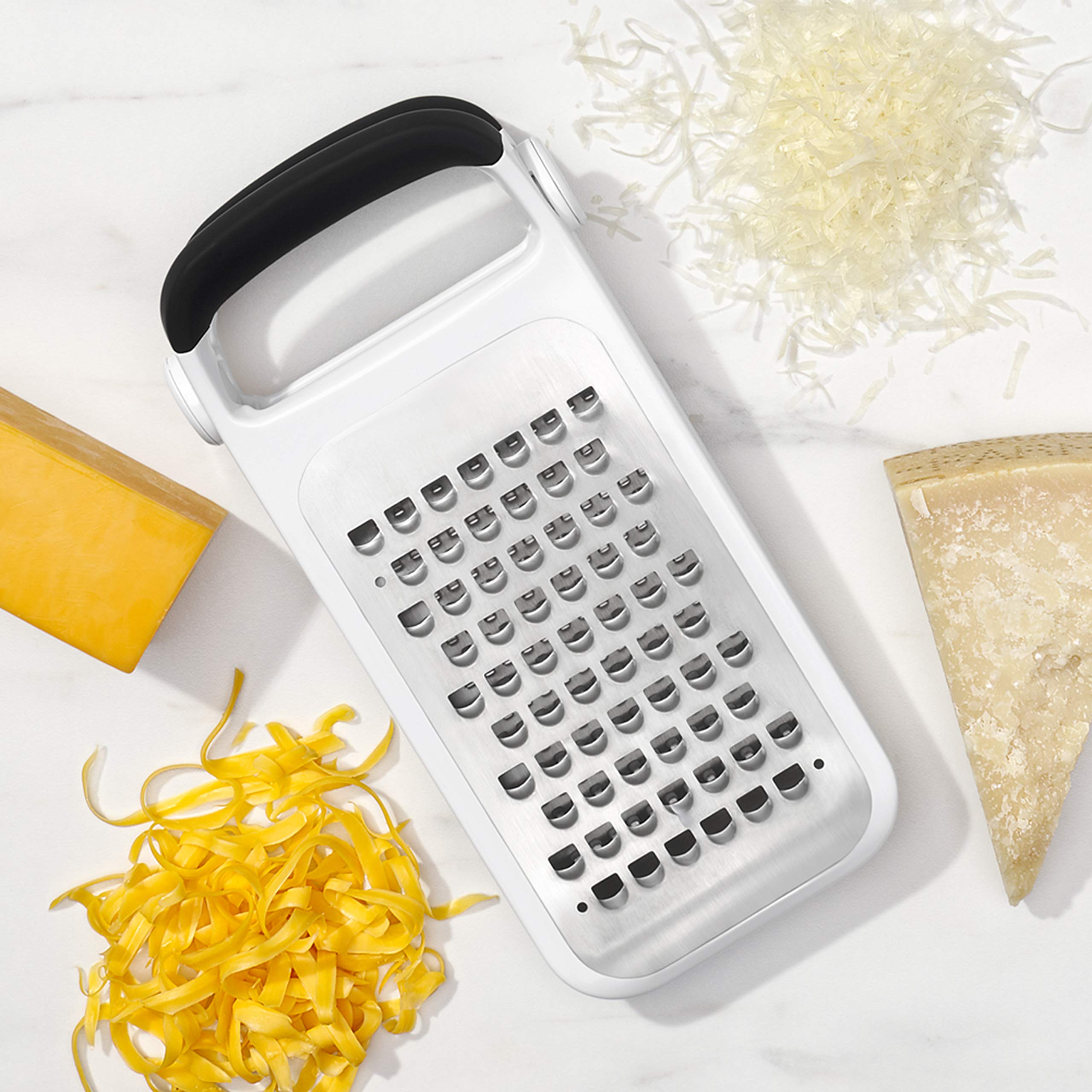 OXO grated cheese on plate showcasing coarse and medium textures for finishing dishes