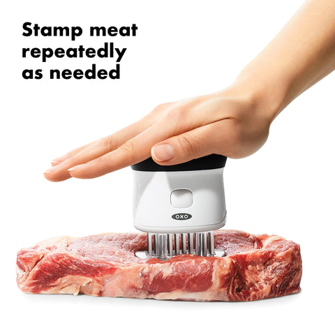 OXO contoured non-slip handle image conveying comfortable, controlled stamping