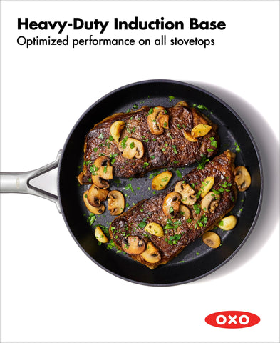 OXO pan searing steak on stovetop showing even heat and easy food release