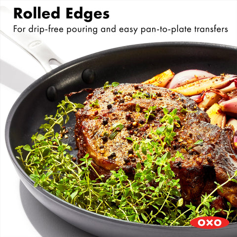 OXO pan beside utensils for scale demonstrating roomy 12-inch capacity for family meals