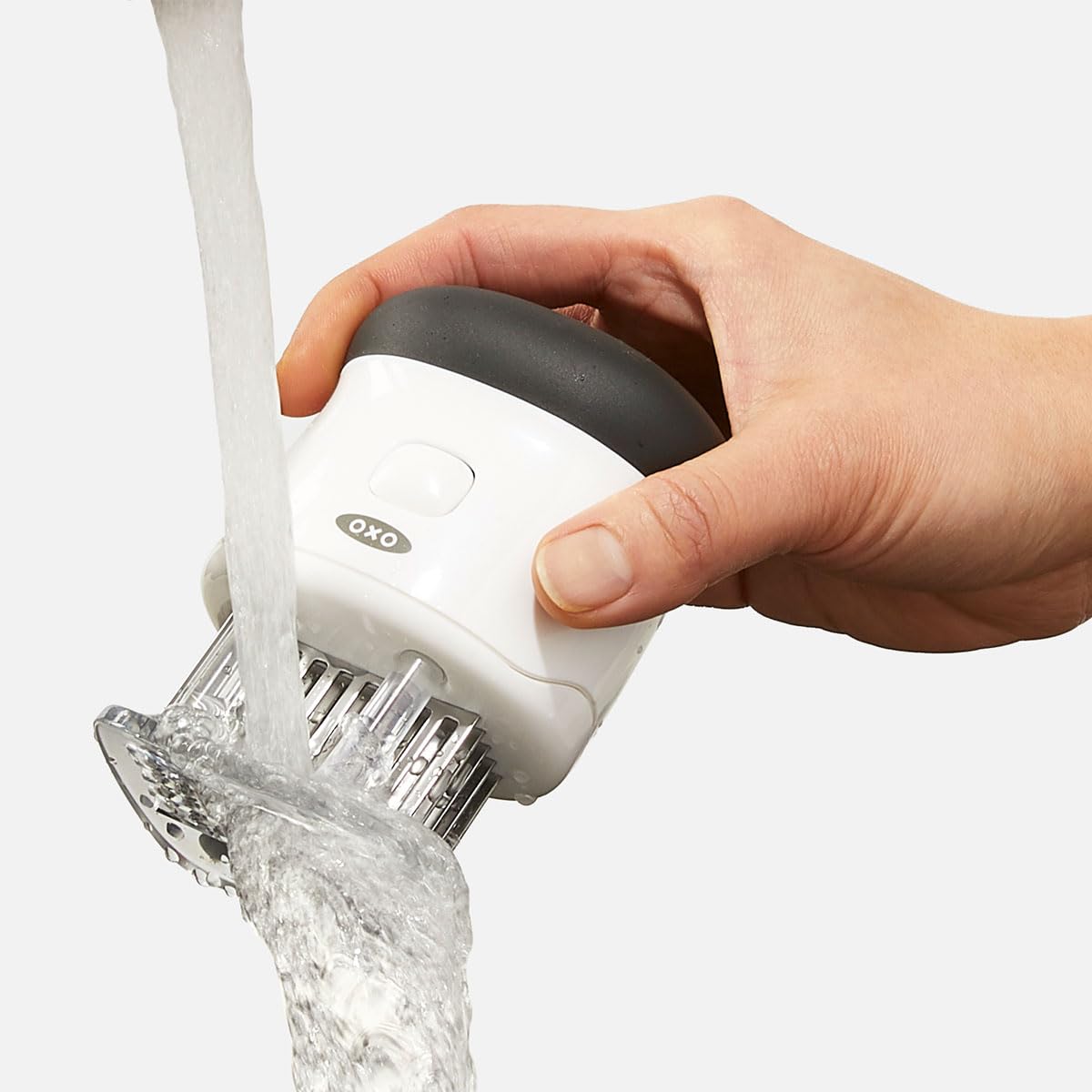 OXO tool beside a hand for scale showing compact size and ergonomic benefit
