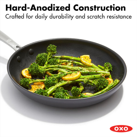 OXO pans on stove with food cooking, demonstrating even heat and performance