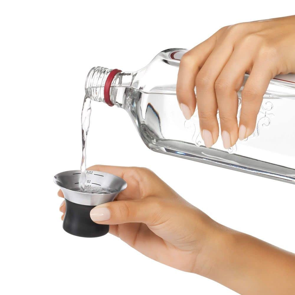 OXO shaker held in hand showing scale and comfortable grip for control