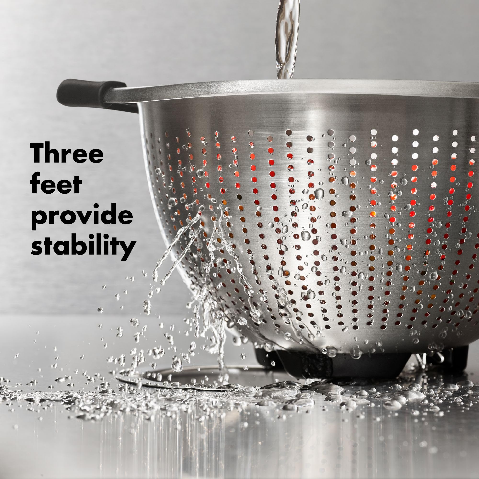 OXO Good Grips strainer draining pasta into pot showing secure control while pouring benefit