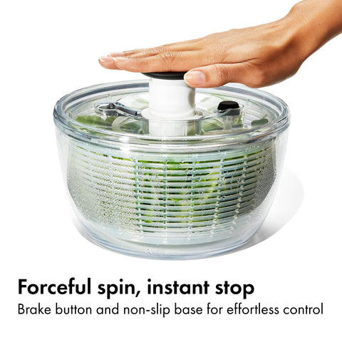 OXO in-use with hands spinning herbs to quickly remove excess water