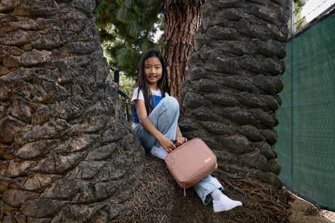 PackIt classic buckle handle clipped to backpack showing hands-free carry benefit