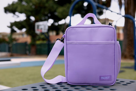 PackIt lavender lunch box in commuter setting demonstrating everyday convenience benefit