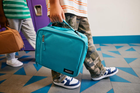 PackIt in-use lunch scene Blue Sky with lunch containers staying cool outdoors