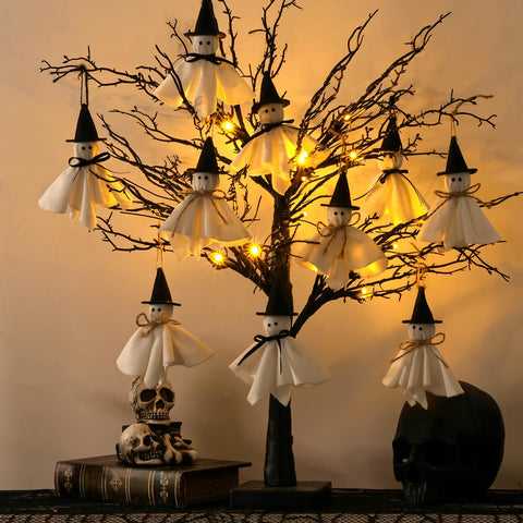 Pawliss tree next to a book showing 27-inch height and compact tabletop scale