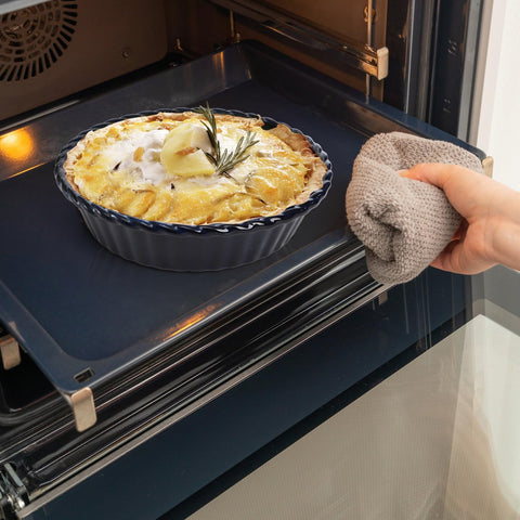 Peohud pans next to utensils showing size scale for family servings