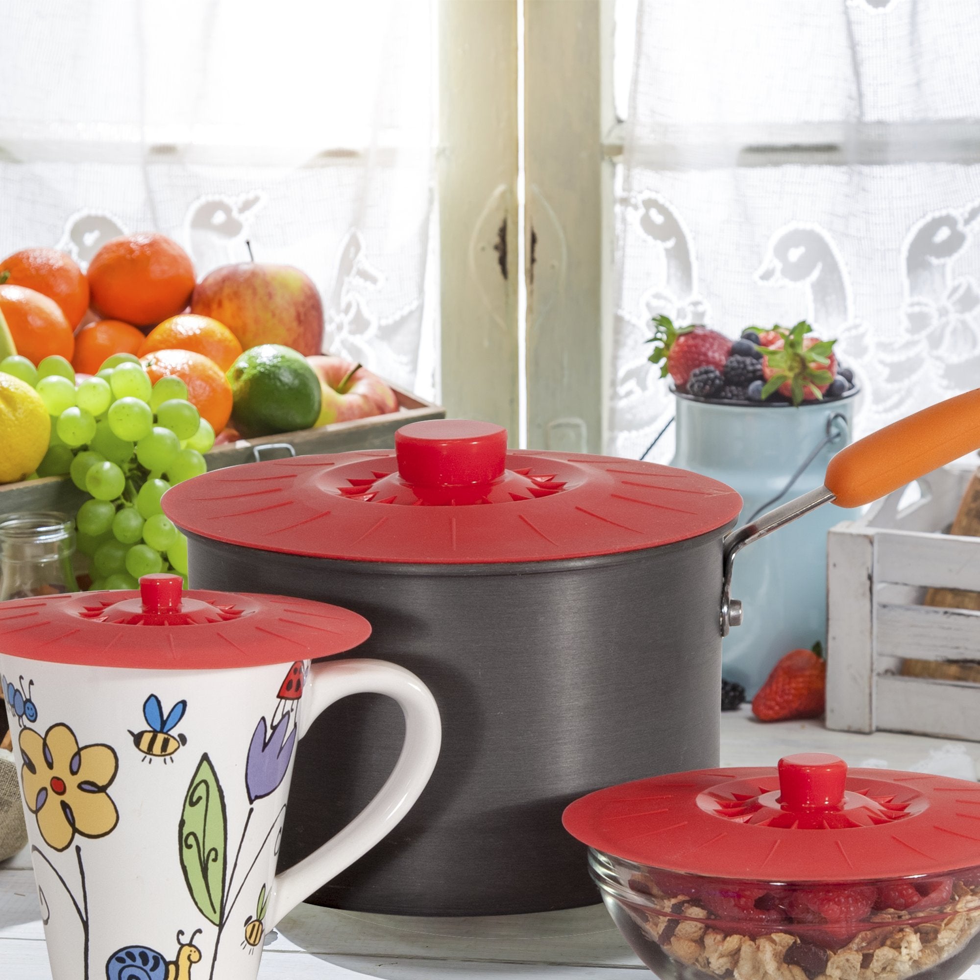 Perfect and Simple red lids on a kitchen table with dishes showing meal prep convenience