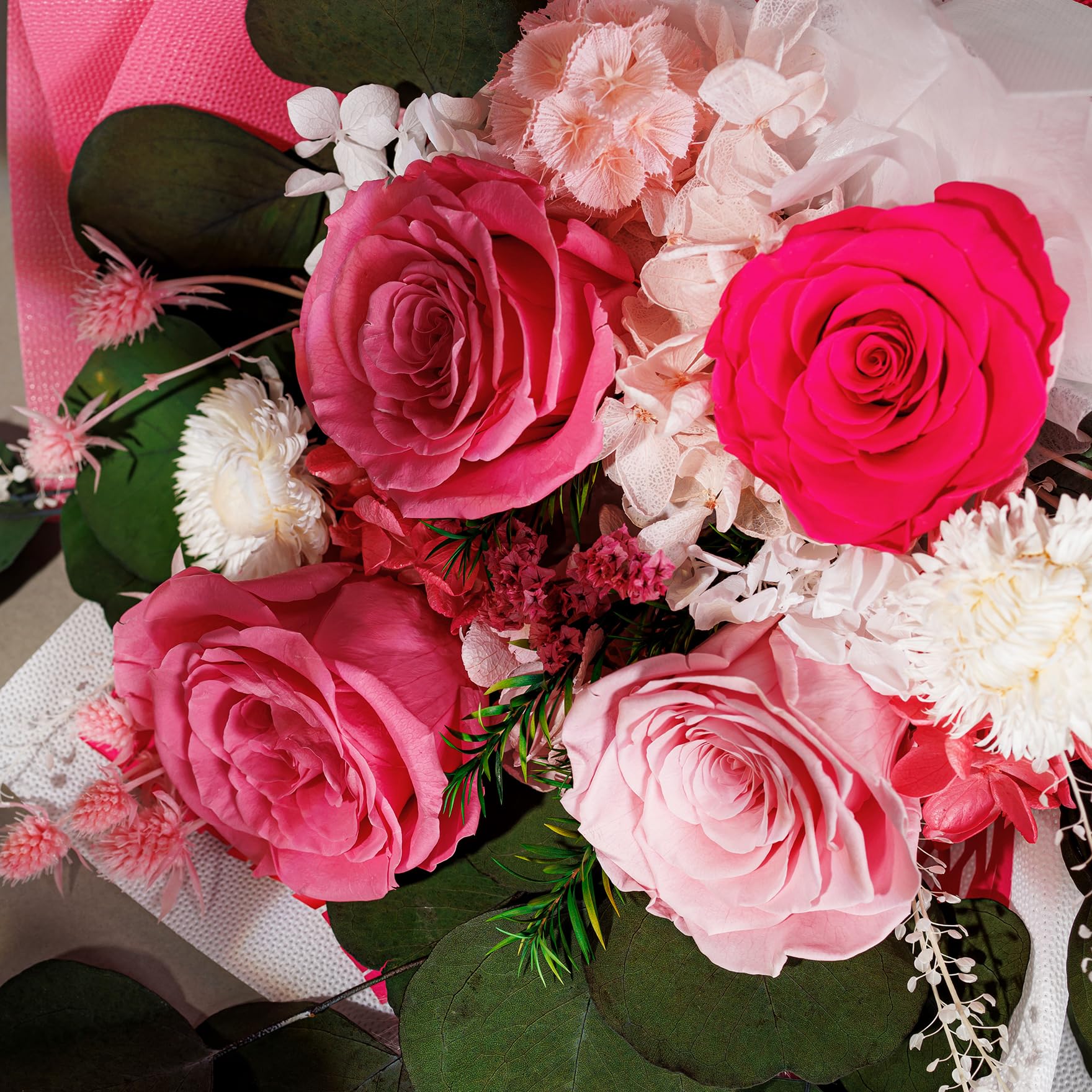 Perfectione Roses bouquet in vase on table adding lasting pink elegance to room