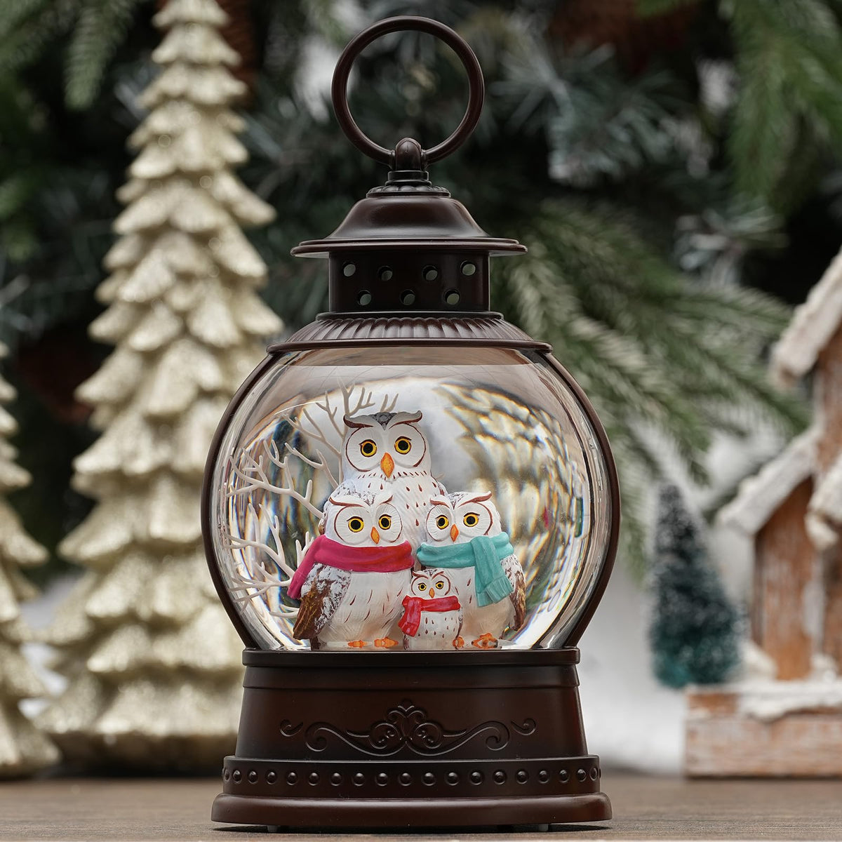 PestiLite front view of owl family snow globe showing festive scene and light
