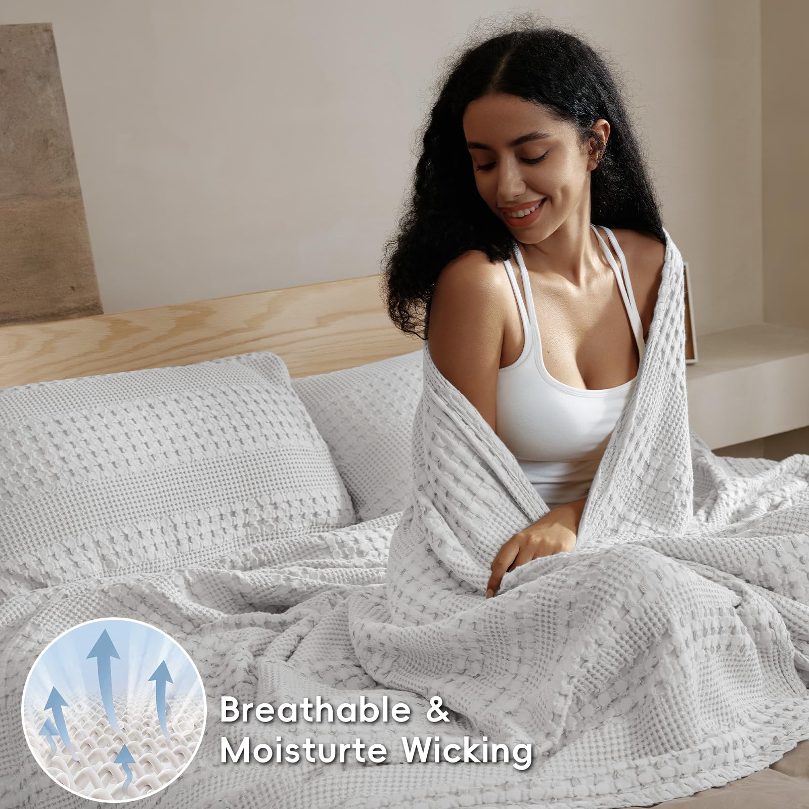 PHF blanket on a styled bed demonstrating cozy layered look for modern interiors