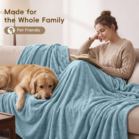PHF blanket draped on couch in living room conveying relaxed warmth