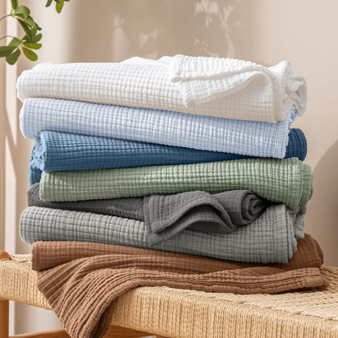 PHF muslin blanket in washer showing easy machine wash care and softness retention